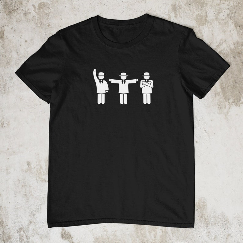 Black t-shirt featuring three black pictogram figures in suits and hats, depicting cricket umpires with different signals.