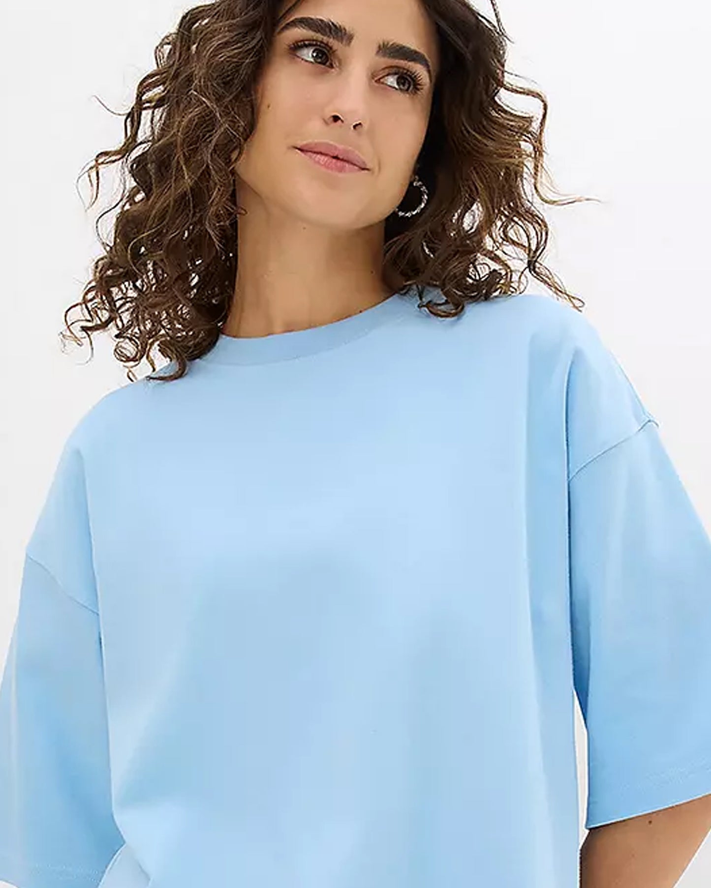 Close Front View Woman in Light Blue Oversized T-Shirt in Front View.