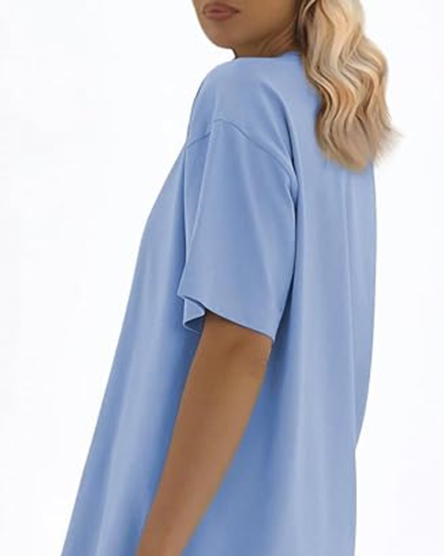 Left sIde view of a person with long blonde hair wearing a light blue oversized t-shirt.