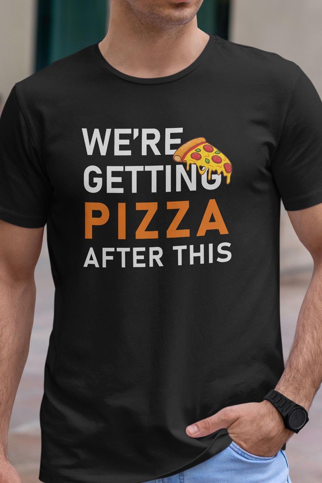 Black t-shirt with "We're Getting Pizza After This" text and a slice of pizza graphic. A fun, relatable design for pizza lovers.