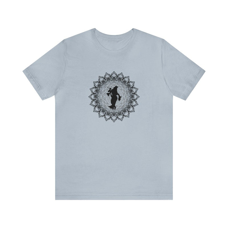 Light blue jersey tee with a black silhouette of Krishna playing flute within a detailed mandala design.