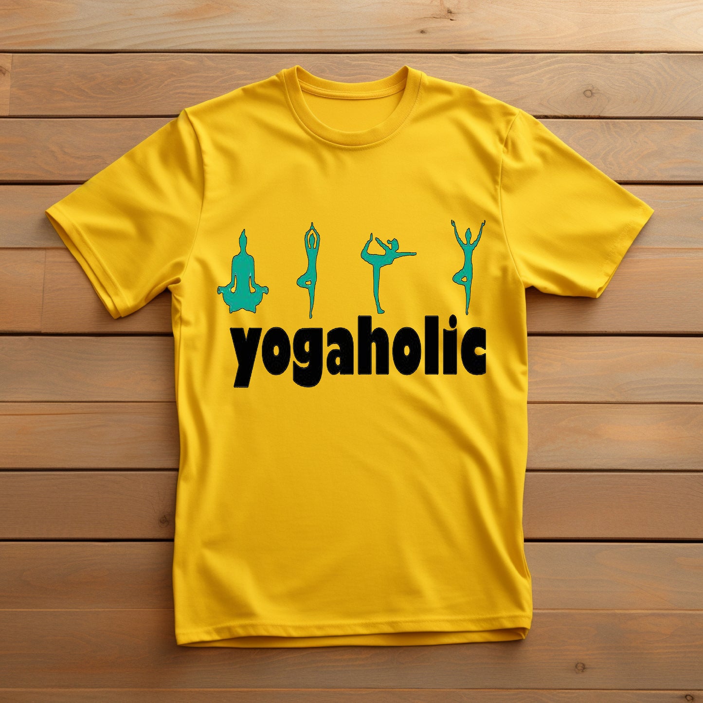 Bright yellow t-shirt displaying "yogaholic" in black text with four teal yoga silhouette poses above it, laid on a wooden surface.