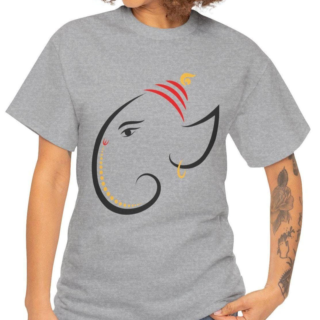 A serene gray T-shirt featuring a minimalist and artistic black-line depiction of Lord Ganesha’s face, adorned with red and gold accents.