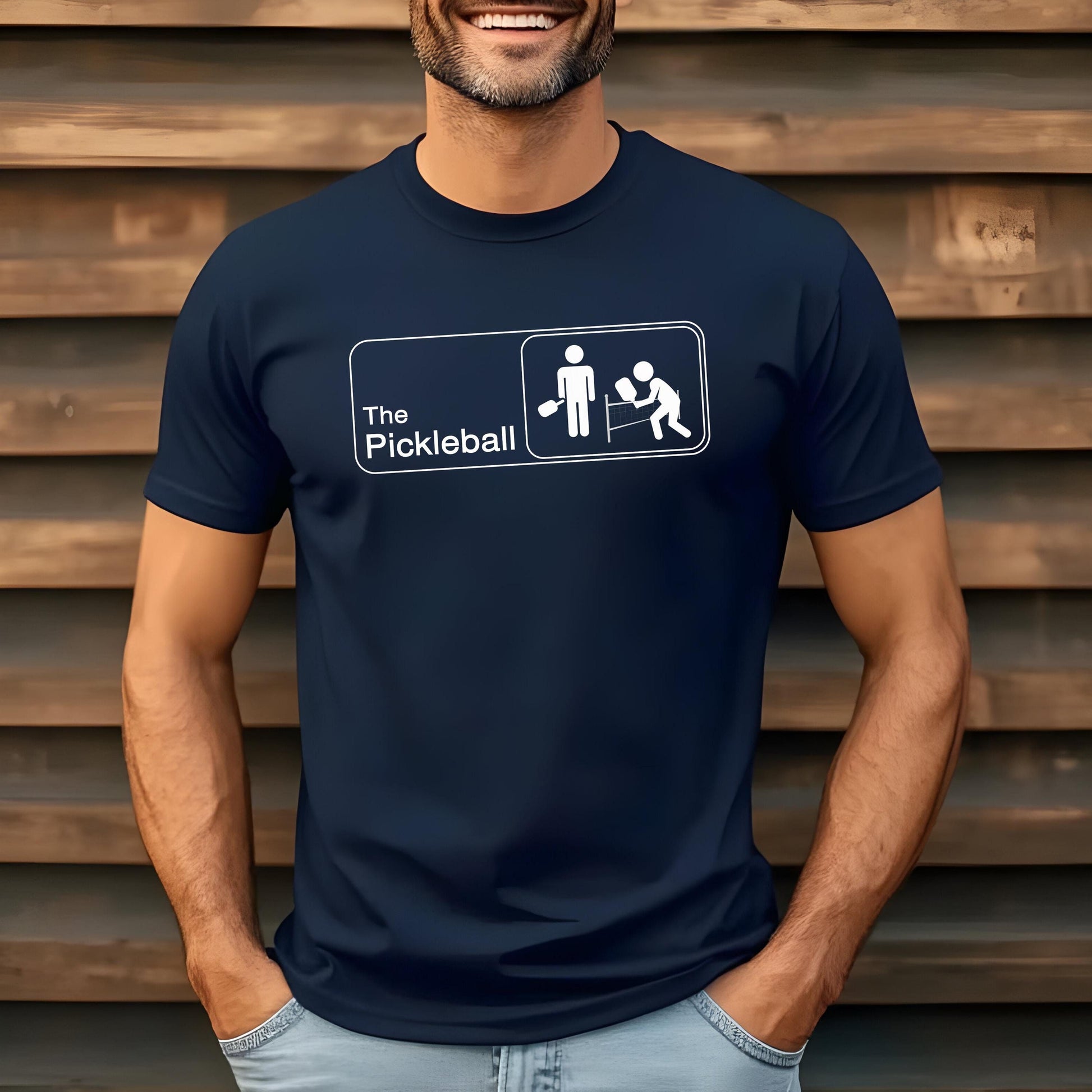 Navy t-shirt with "The Pickleball" text and stick figure player graphic.