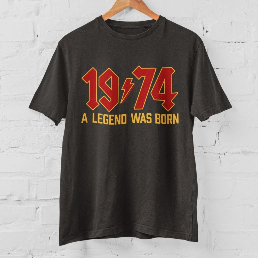 Dark grey t-shirt with "1974 A Legend Was Born" in red and gold vintage lettering.  Classic fit, ideal for 50th birthday celebrations.