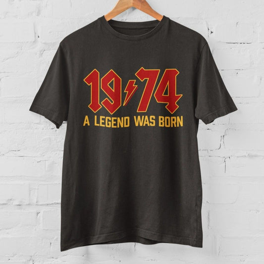 Dark grey t-shirt with "1974 A Legend Was Born" in red and gold vintage lettering.  Classic fit, ideal for 50th birthday celebrations.