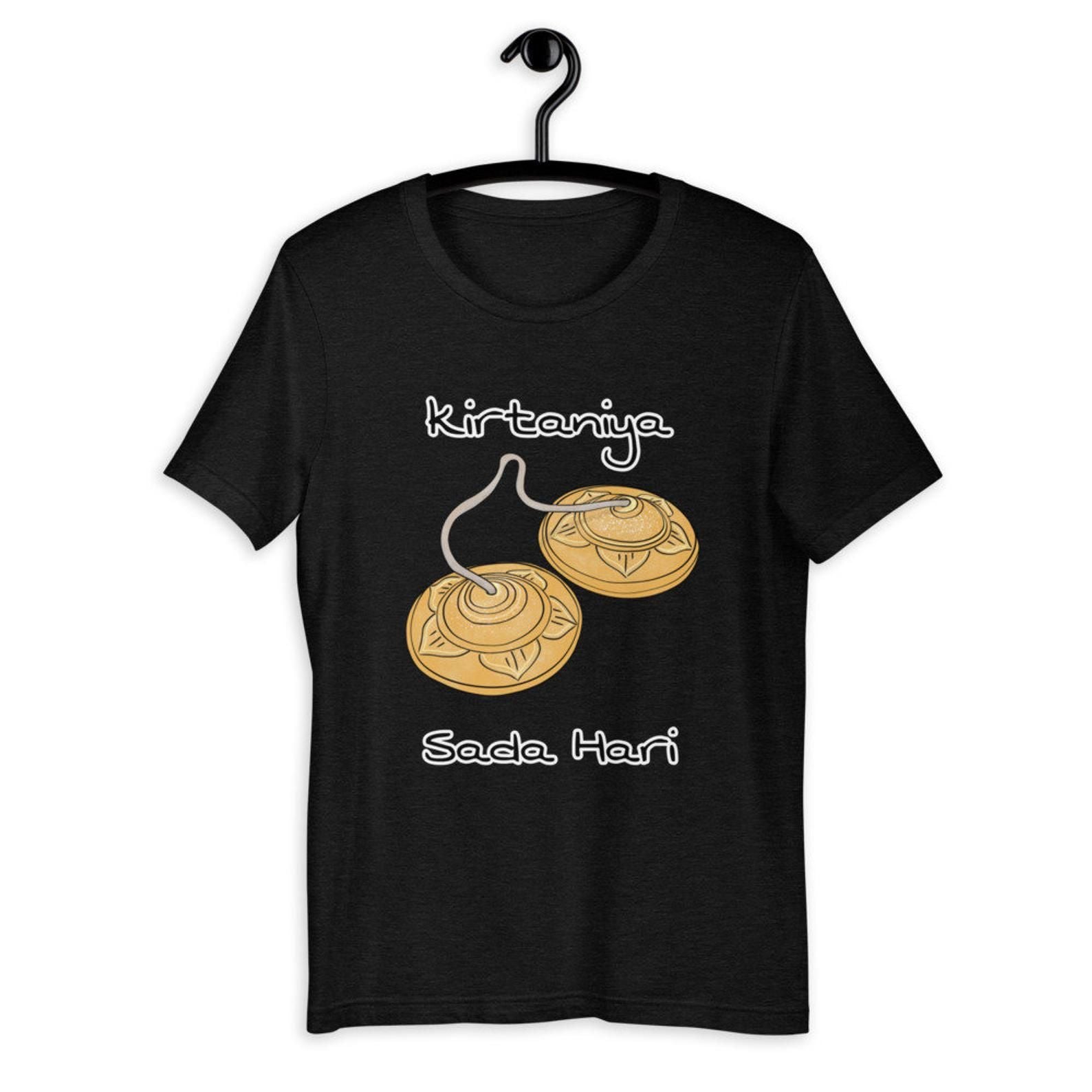 A black t-shirt with "Kirtaniya" and "Sada Hari" alongside an illustration of cymbals, symbolizing devotional music.