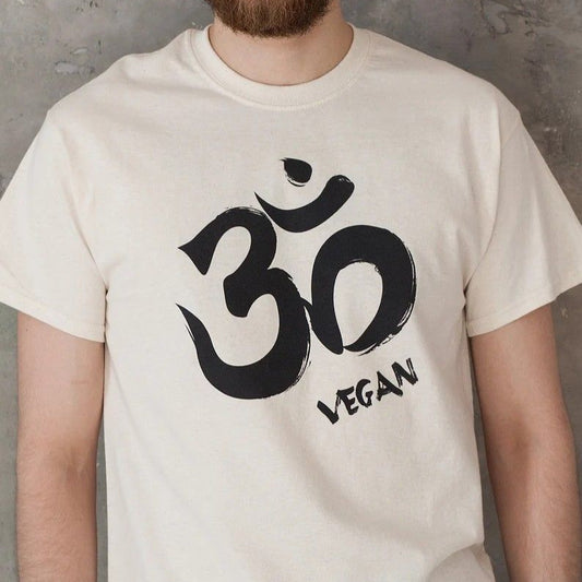 Off-white T-Shirt with a black Om symbol and the word "VEGAN" written below it.