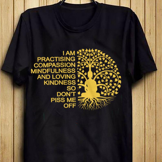 A black t-shirt featuring a golden Bodhi tree and Buddha silhouette with a humorous message about compassion and boundaries.