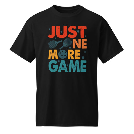 Black t-shirt with "Just one more game" text, paddles, and pickleball graphic in retro colors.
