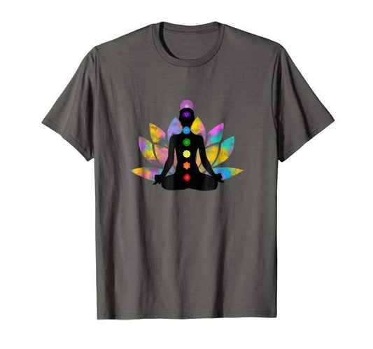 Dark grey T-Shirt with a silhouette graphic of a person meditating in a lotus pose, displaying the seven chakra colors along their body, set against a colorful lotus flower background.