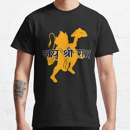 Black T-Shirt with a gold silhouette graphic of Hanuman carrying a mountain and "जय श्री राम" (Jai Shri Ram) written in gold Devanagari script.