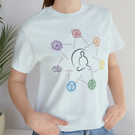 Light blue T-Shirt with a graphic of a person in a yoga pose surrounded by seven colorful chakra symbols arranged in a circle.