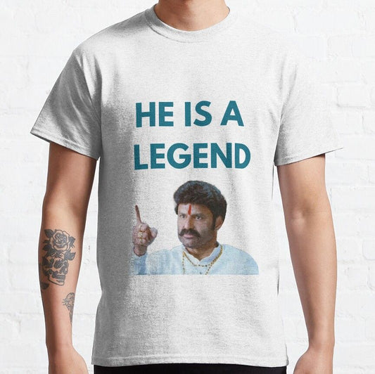 Light gray t-shirt with the English phrase 'HE IS A LEGEND' and an image of Telugu actor Nandamuri Balakrishna pointing.  Tribute to the actor on a comfortable t-shirt.