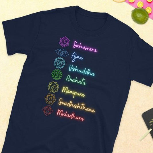 Black T-Shirt with a white mandala design and seven colorful chakra symbols arranged vertically, suitable for yoga or meditation.