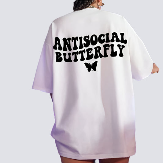 White oversize t-shirt with "ANTISOCIAL BUTTERFLY" printed in bold, black lettering across the upper back, and a small, black butterfly graphic beneath the text.