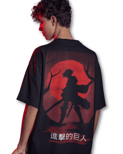 Black t-shirt with a silhouette of Eren Yeager from Attack on Titan against a red moon, worn by a young man.