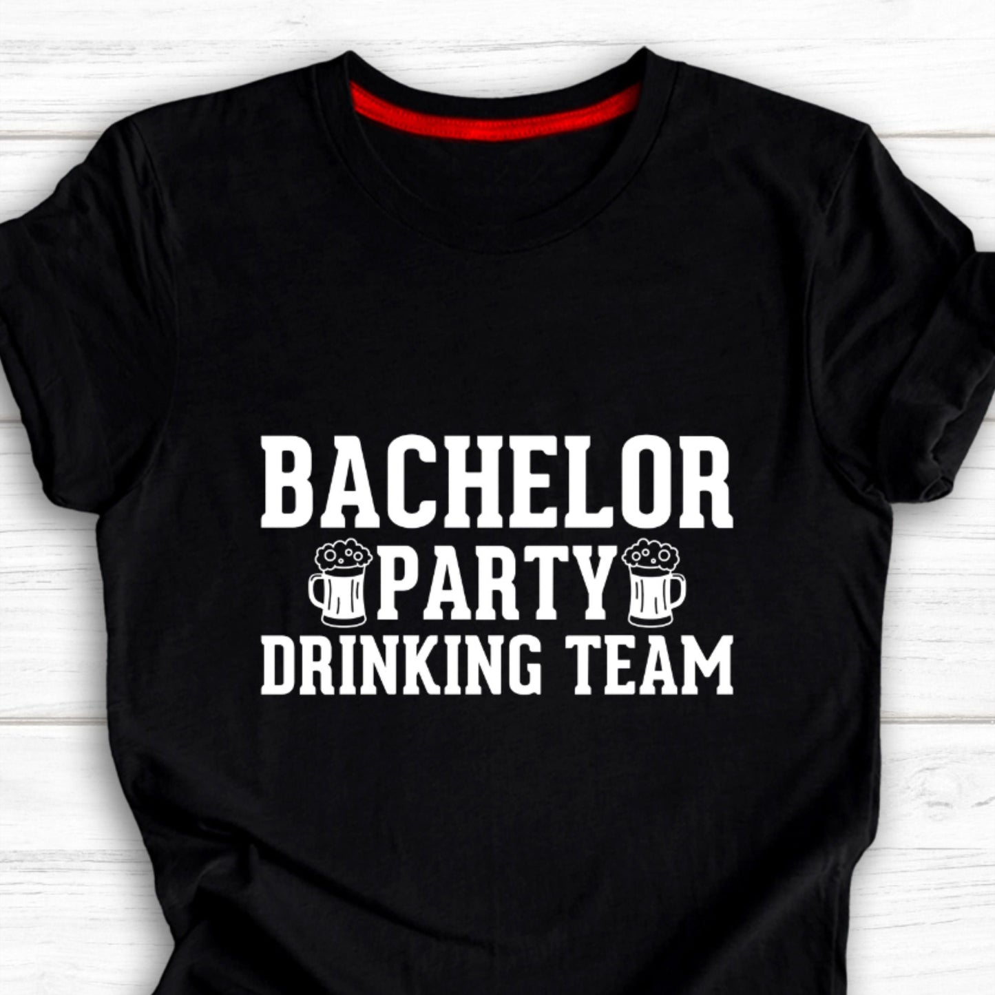 Black cotton t-shirt with white text "BACHELOR PARTY DRINKING TEAM" and two graphic beer mugs.