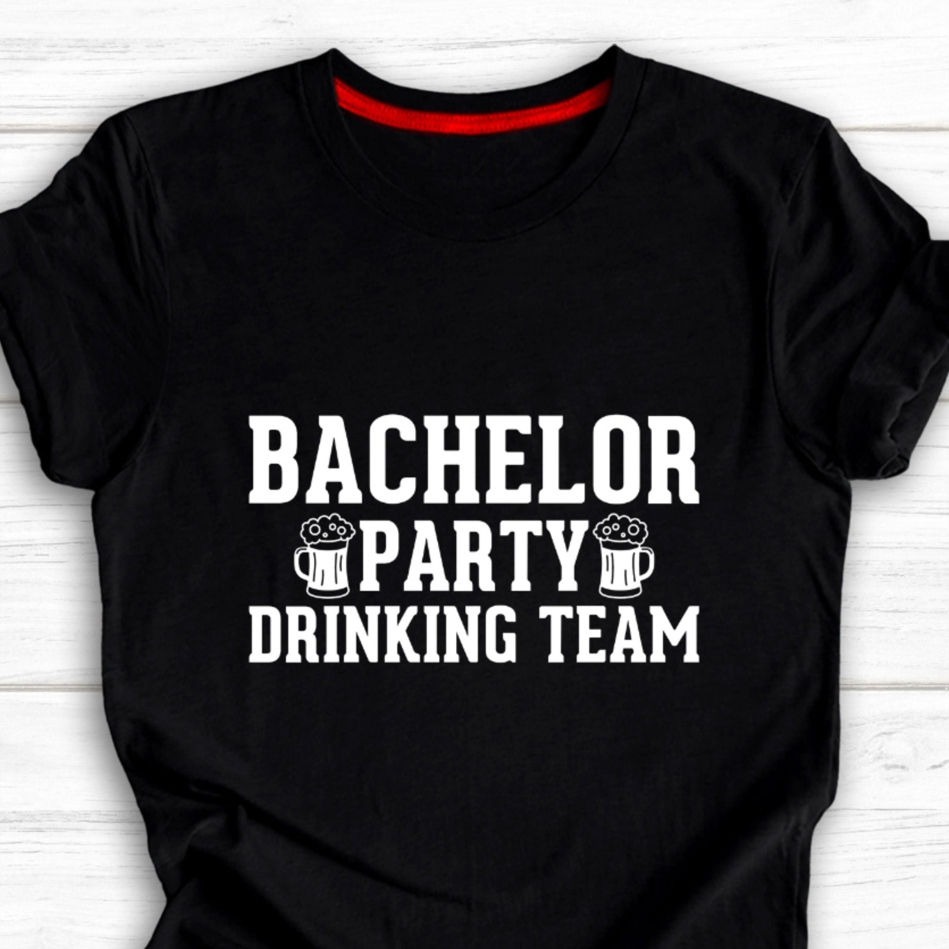 Black cotton t-shirt with white text "BACHELOR PARTY DRINKING TEAM" and two graphic beer mugs.