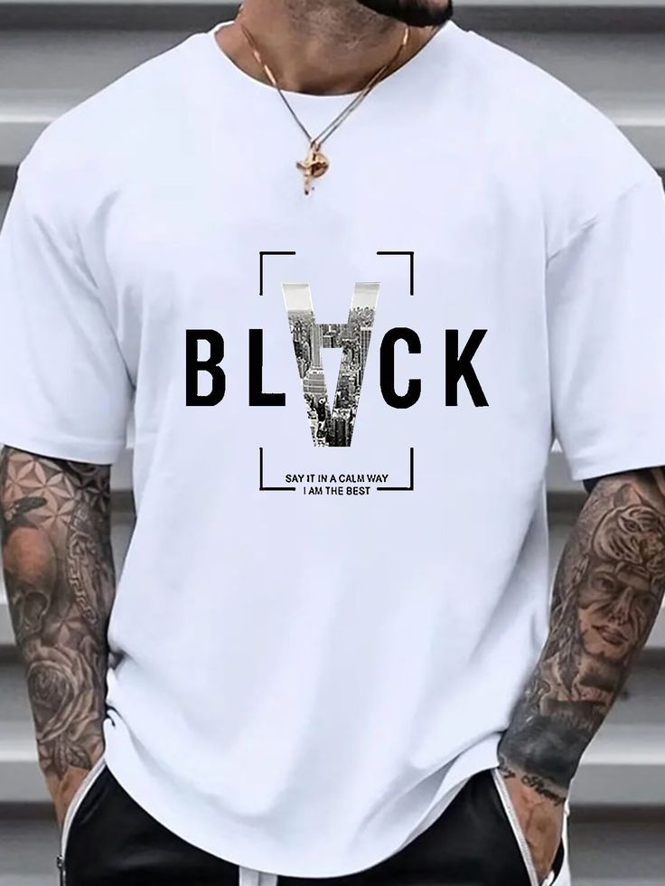 Light-colored oversize t-shirt with "Black" text, a cityscape graphic within the letter "V", and a short quote.