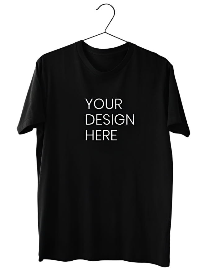 A plain black cotton T-Shirt is displayed hanging on a black hanger against a light gray background, featuring a central white text area that reads "YOUR DESIGN HERE" indicating space for personalization.