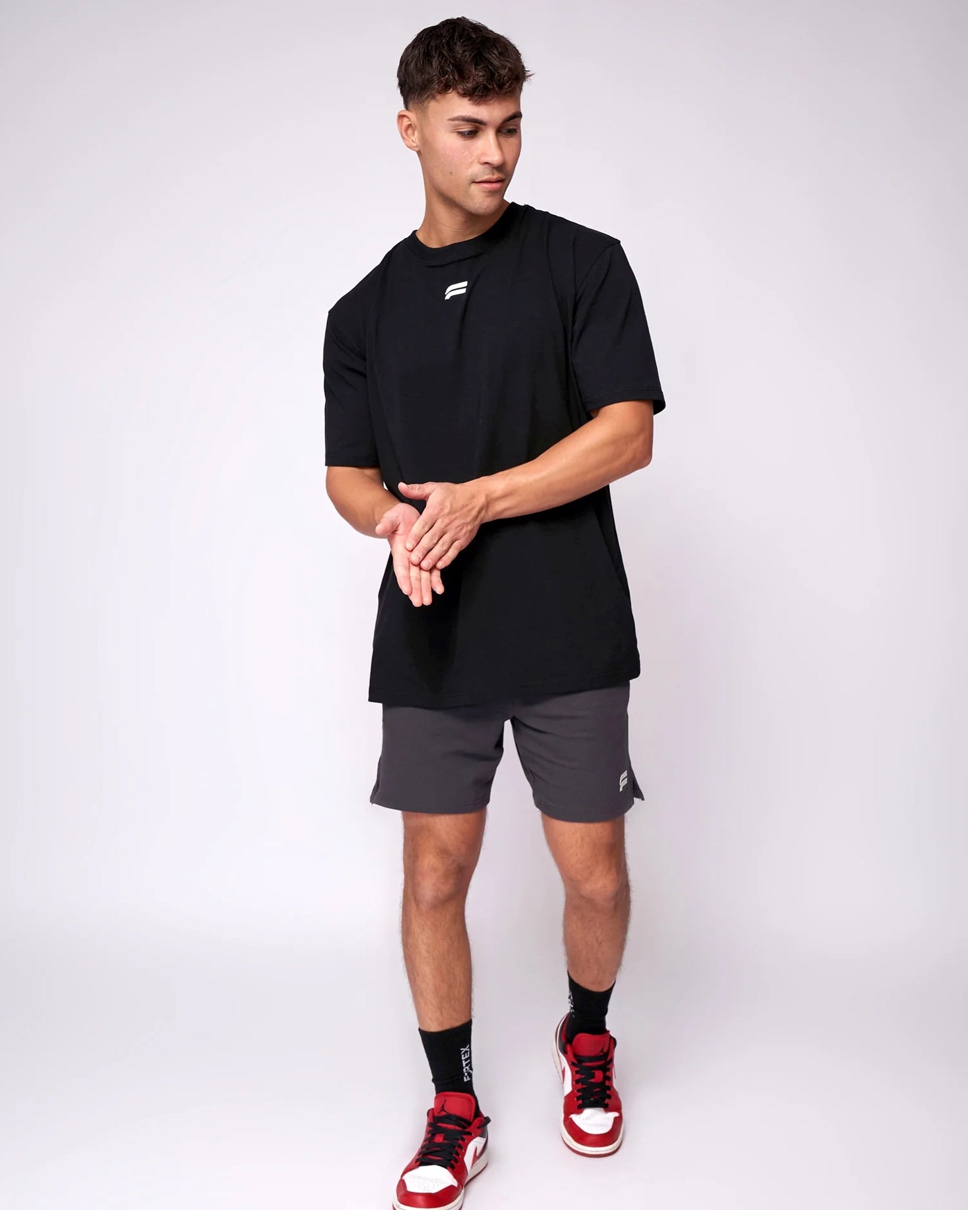  Backside view a classic black T-shirt with a simple, athletic design.
