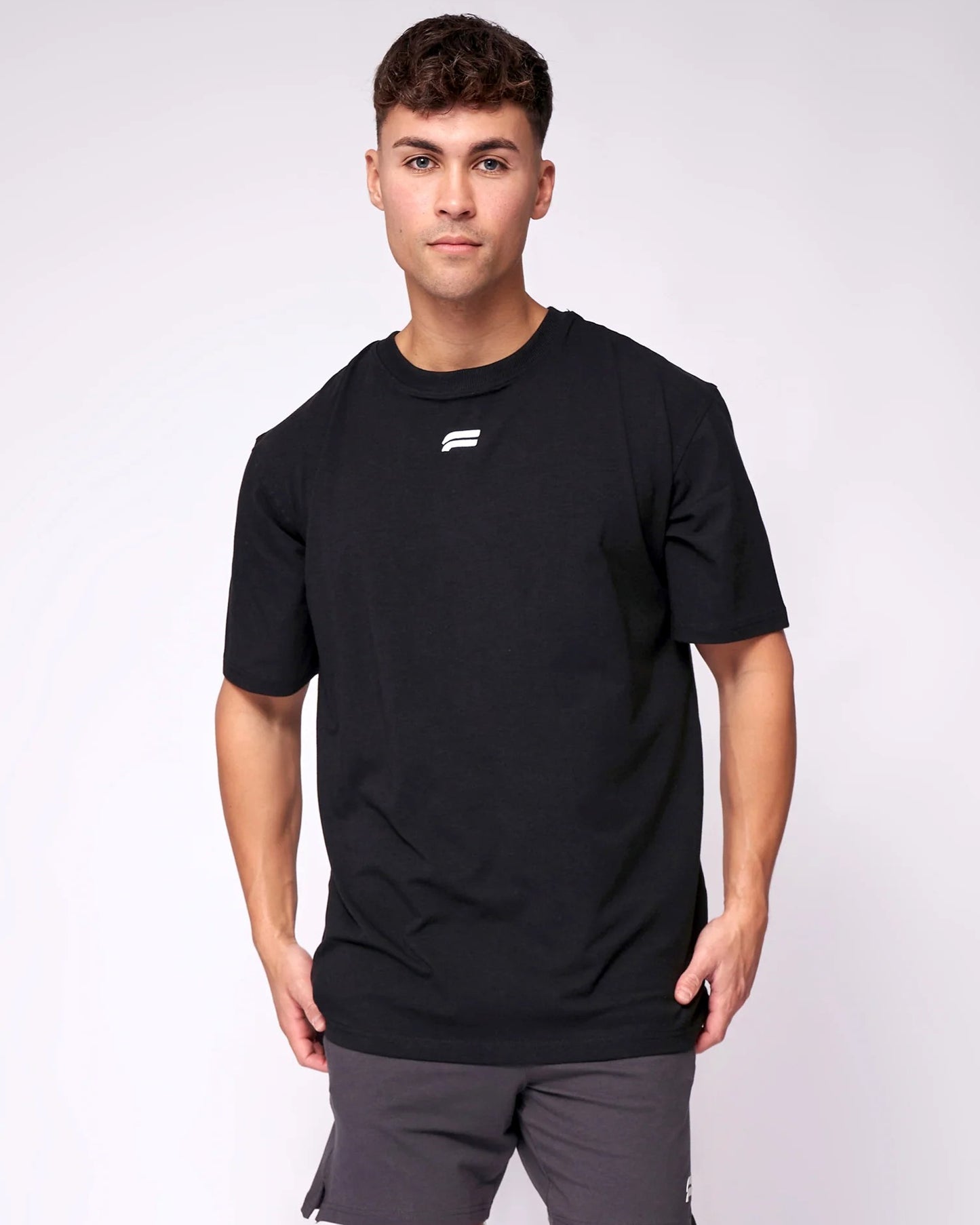 A man wearing a black t-shirt and _Athletic_Look_for_best_Occation front view