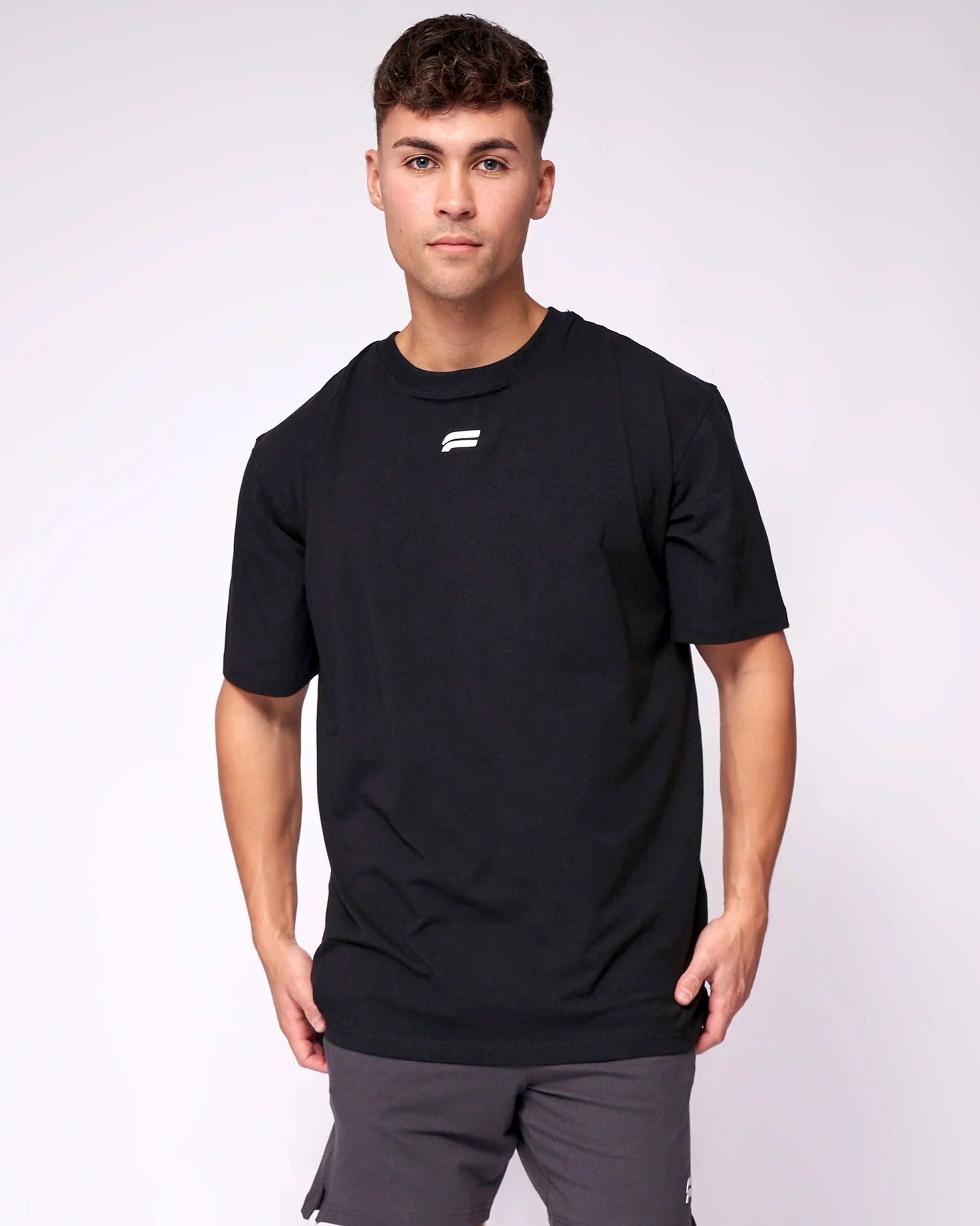 A man wearing a black t-shirt and _Athletic_Look_for_best_Occation front view