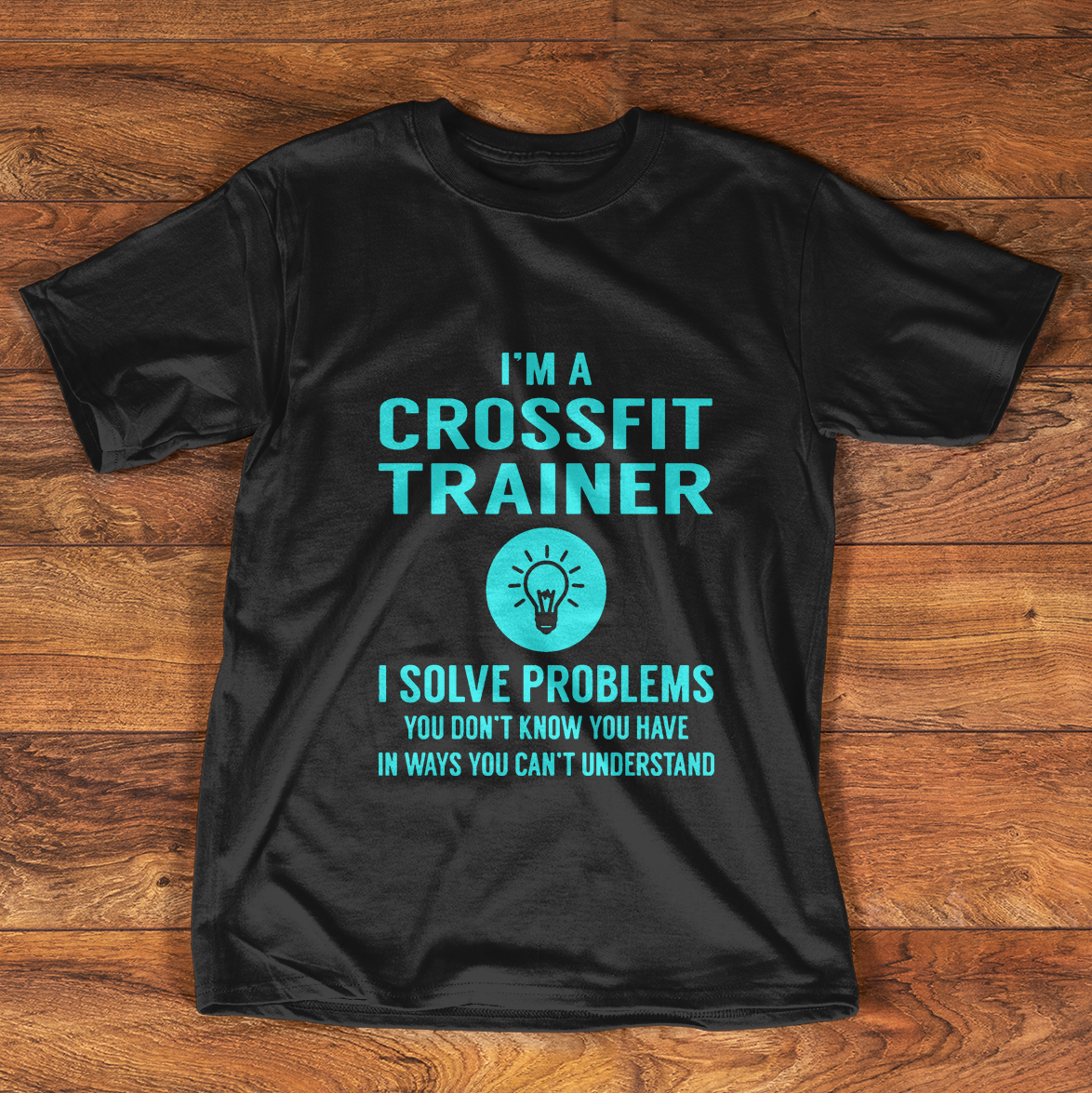 Black t-shirt with "I'M A CROSSFIT TRAINER" text and lightbulb icon.