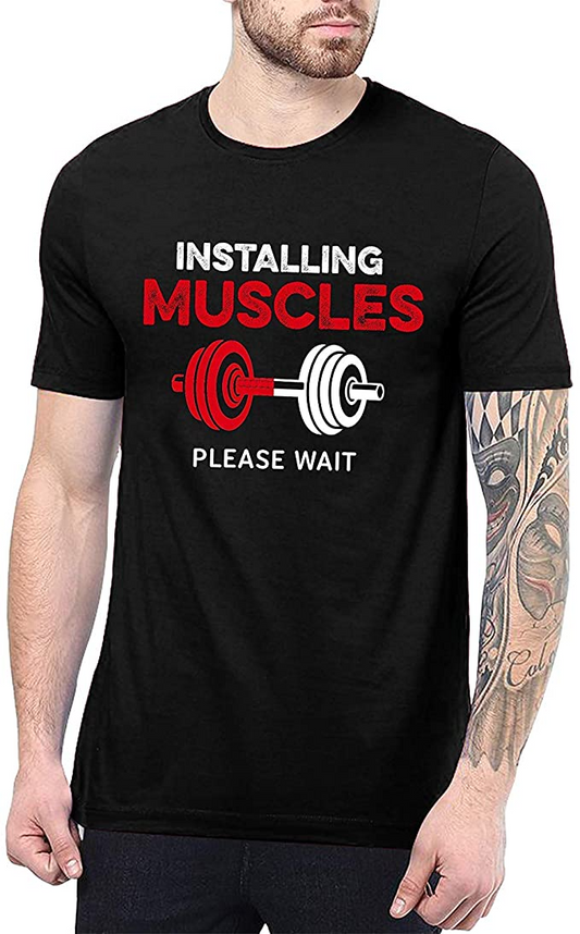 Black t-shirt with "Installing Muscles Please Wait" text and dumbbell graphic on man.