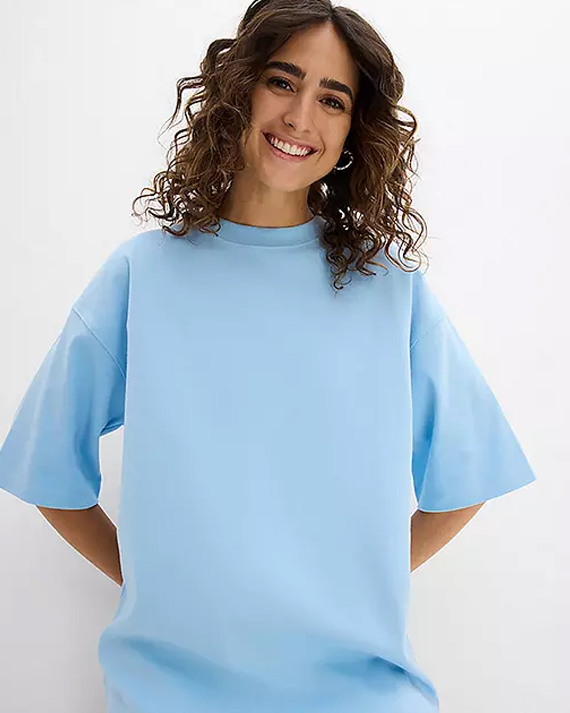 Smiling Woman in Blue Oversized T-Shirt Front View in Round Neck 