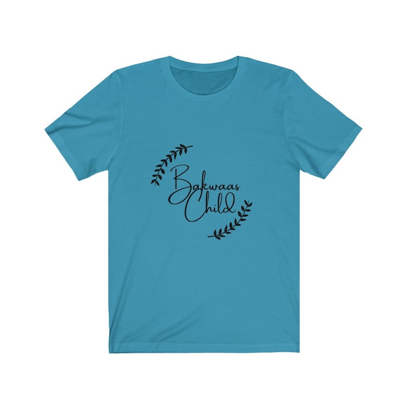 Blue t-shirt featuring the text "Bakwaas Child" in a stylish font, accompanied by leaf graphics.