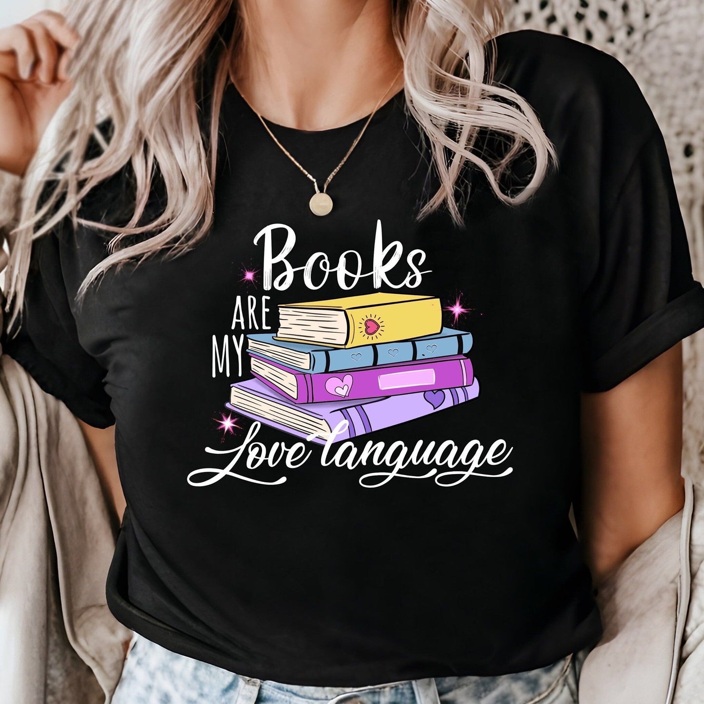 Black t-shirt with "Books Are My Love Language" text and a stack of colorful books graphic. A perfect gift for book lovers and avid readers.