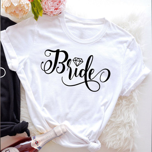 White cotton t-shirt with the word "Bride" in a flowing black script font incorporating a diamond graphic.