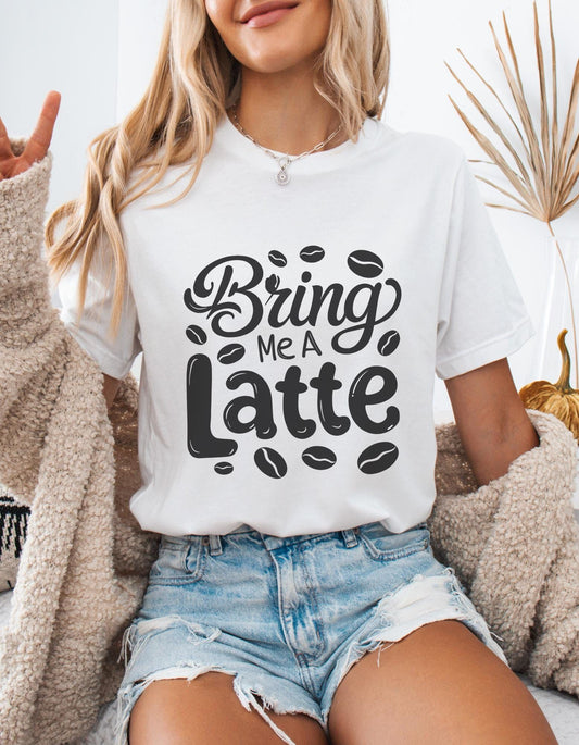 White t-shirt with "Bring Me a Latte" text and coffee bean graphics. A casual design for latte enthusiasts.