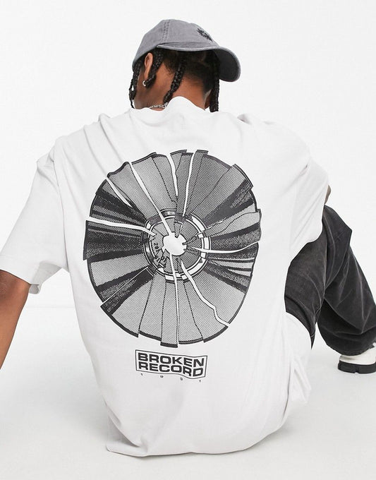 Light-colored oversized t-shirt with a "Broken Record" graphic featuring a shattered record design on the back.