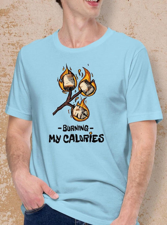 Light blue t-shirt with a graphic of burning marshmallows and "Burning My Calories" text.  A fun, humorous design for marshmallow lovers.