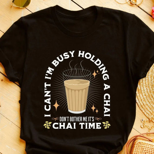 Black t-shirt with "I Can't I'm Busy Holding a Chai Don't Bother Me It's Chai Time" text and a glass of chai graphic. A humorous design for busy moms who love their chai.