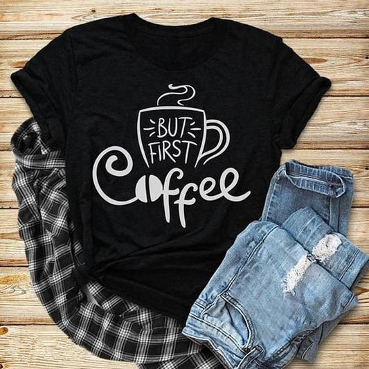 Black t-shirt with "But First Coffee" text and a coffee cup graphic. A simple design for coffee enthusiasts.