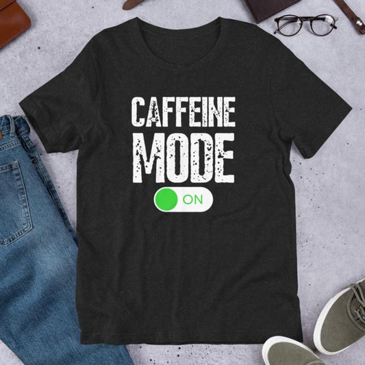 Dark gray t-shirt with "Caffeine Mode On" text and a green "ON" button graphic.  A fun design for coffee enthusiasts.