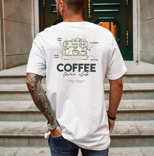  White t-shirt with a detailed line drawing of a coffee machine and "Coffee Lover Club" text. A stylish design for coffee enthusiasts.