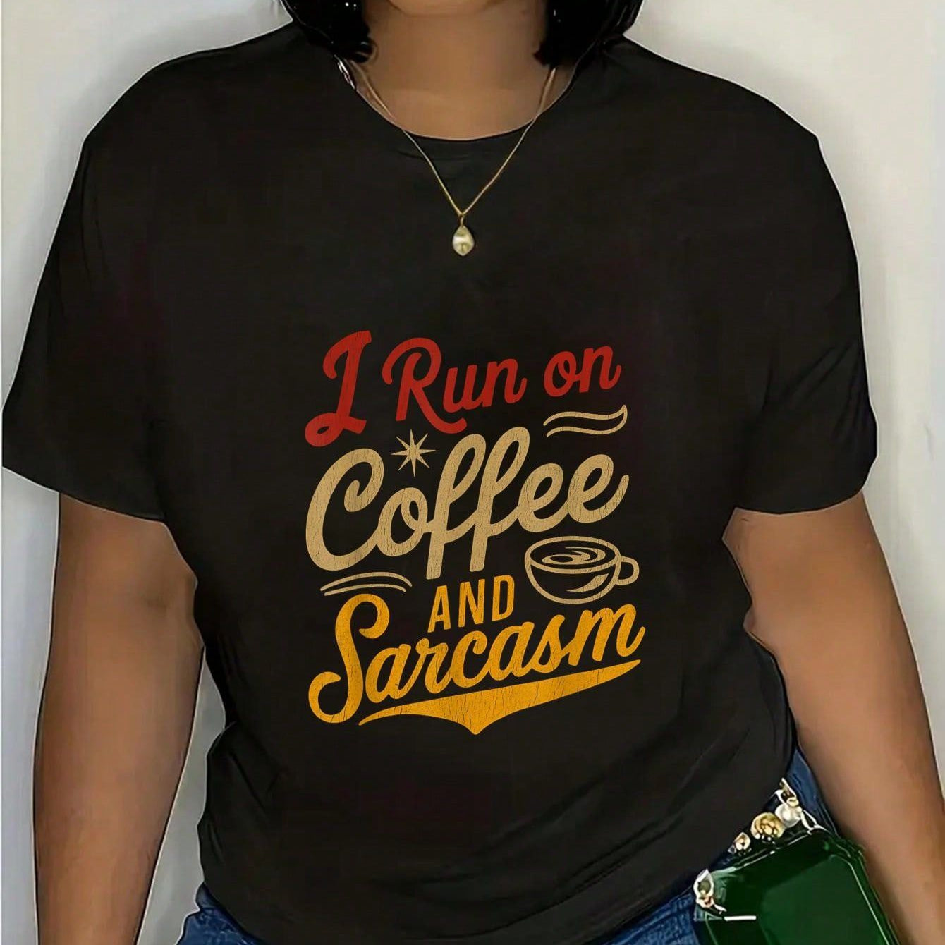 Black t-shirt with "I Run on Coffee and Sarcasm" text worn by a person with dark skin.