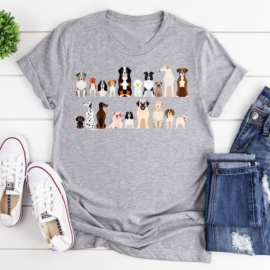  A gray t-shirt with a row of cartoon dog breeds is laid flat with shoes and jeans.