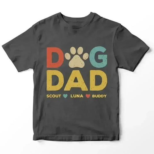 Dark gray t-shirt with "DOG DAD" in colorful letters, a paw print, and dog names: Scout, Luna, Buddy.