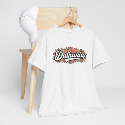 White cotton t-shirt with "Dulhania" in a stylized script surrounded by a floral design with red flowers and green leaves, suggesting a bride's celebratory t-shirt.