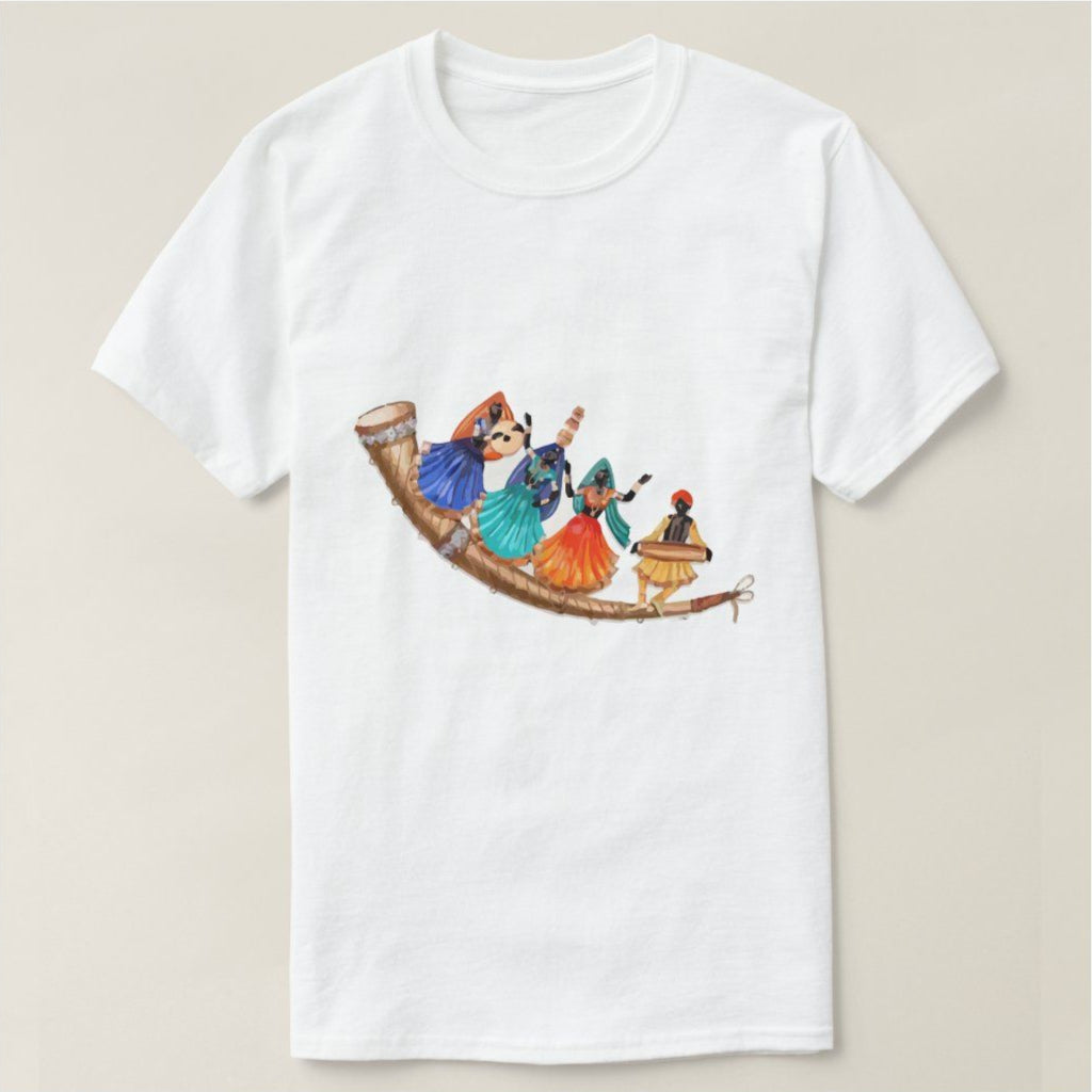 White t-shirt with an illustration of four figures in colorful attire performing a Garba dance, standing on a large, curved horn or musical instrument. Cotton blend t-shirts, available in various sizes.