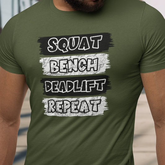 Green t-shirt with "SQUAT BENCH DEADLIFT REPEAT" text on muscular man.