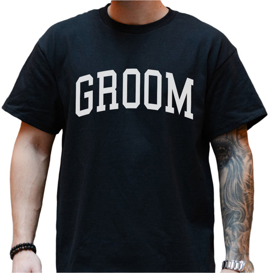 Black cotton t-shirt with the word "GROOM" printed in large, white, sans-serif block letters on the chest.