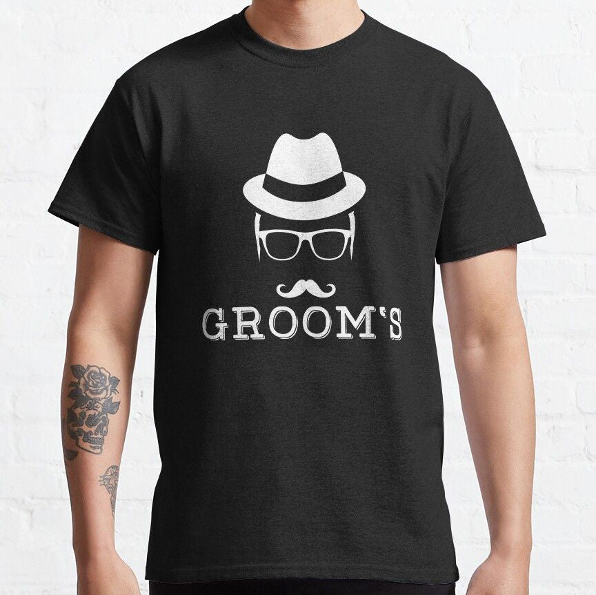 Black cotton t-shirt with a white graphic of a fedora hat, glasses, and a mustache above the text "GROOM'S".