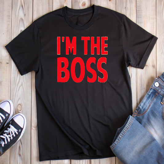 Black t-shirt with bold red text "I'M THE BOSS" outlined in white, styled with jeans and black and white sneakers.